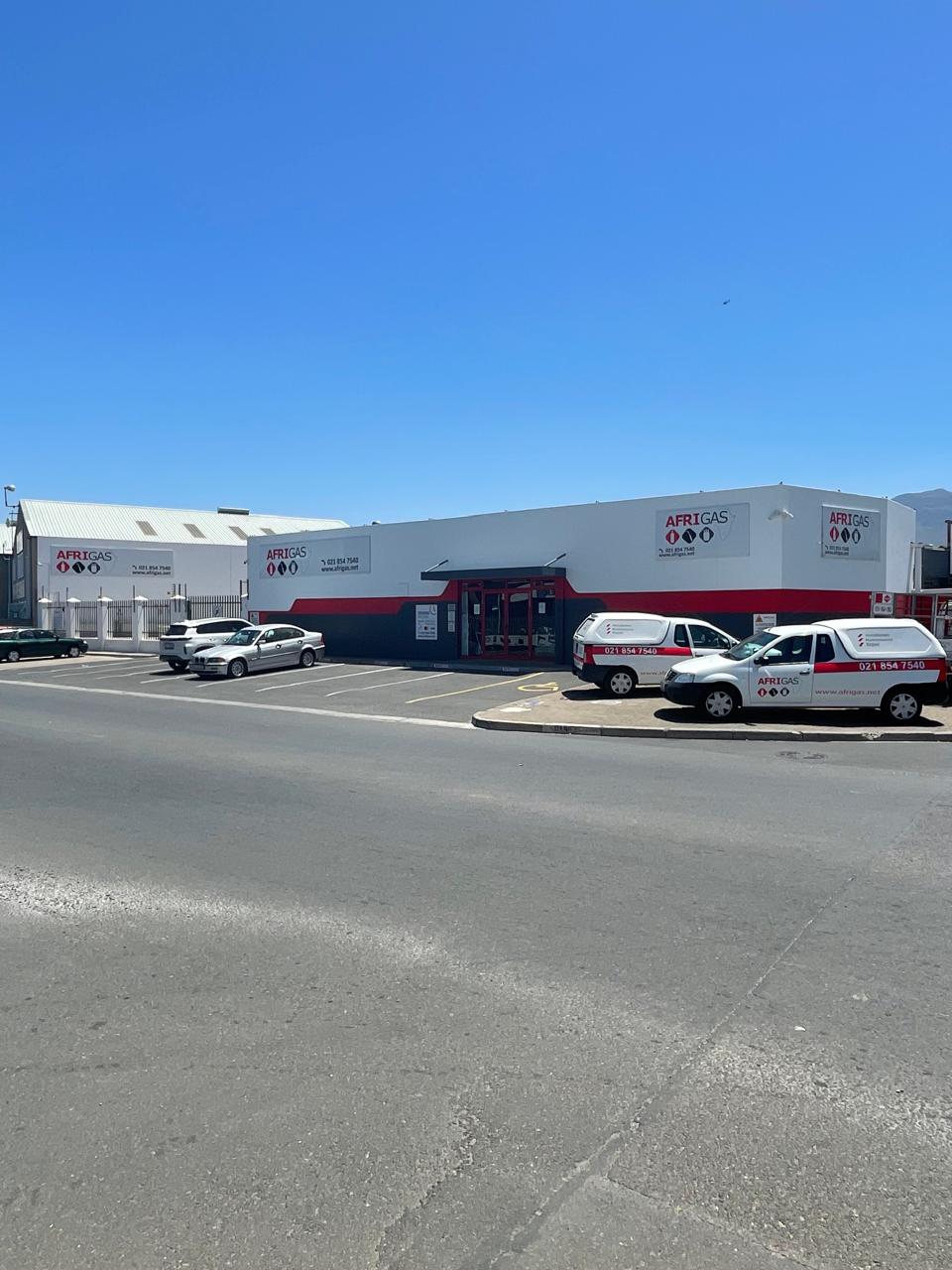 An Afrigas branded depot building with delivery vehicles parked outside